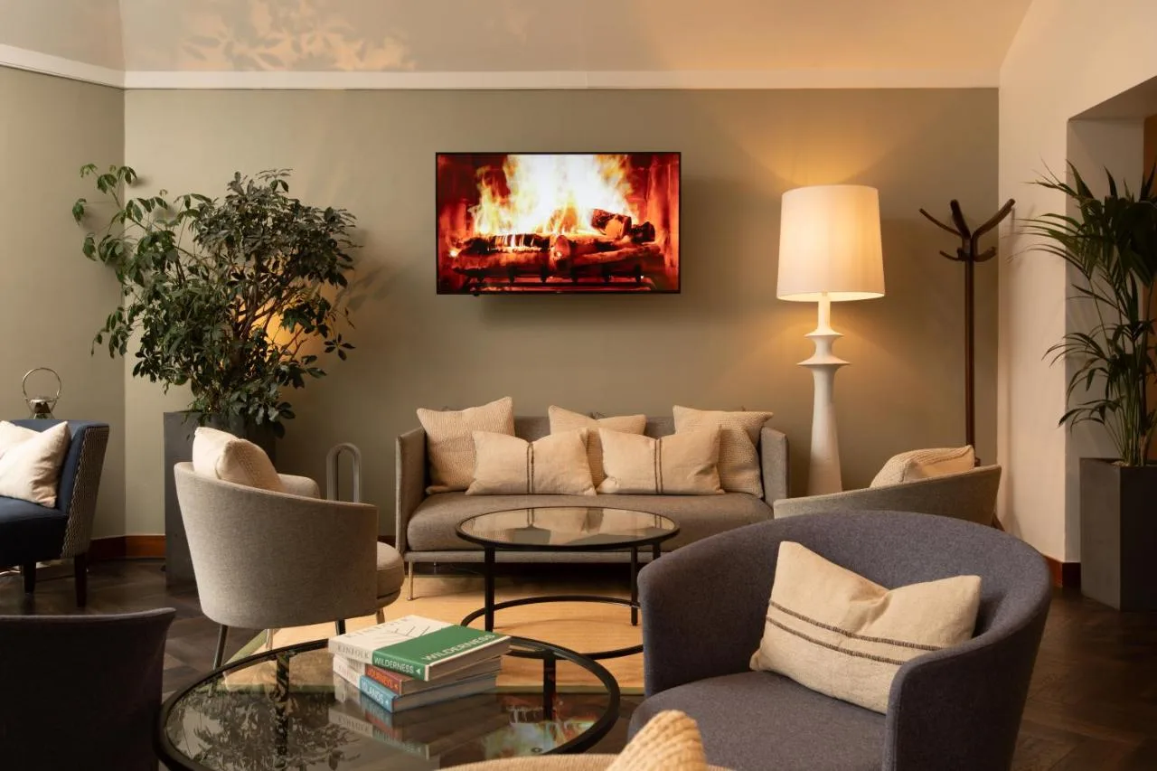 a living room with couches and a fireplace at The Scholar in Edinburgh