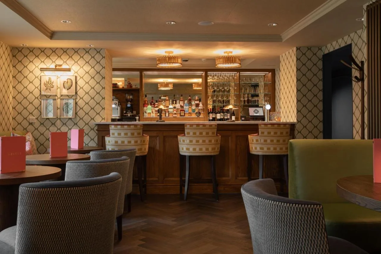 a bar in a restaurant with chairs and tables at The Scholar in Edinburgh