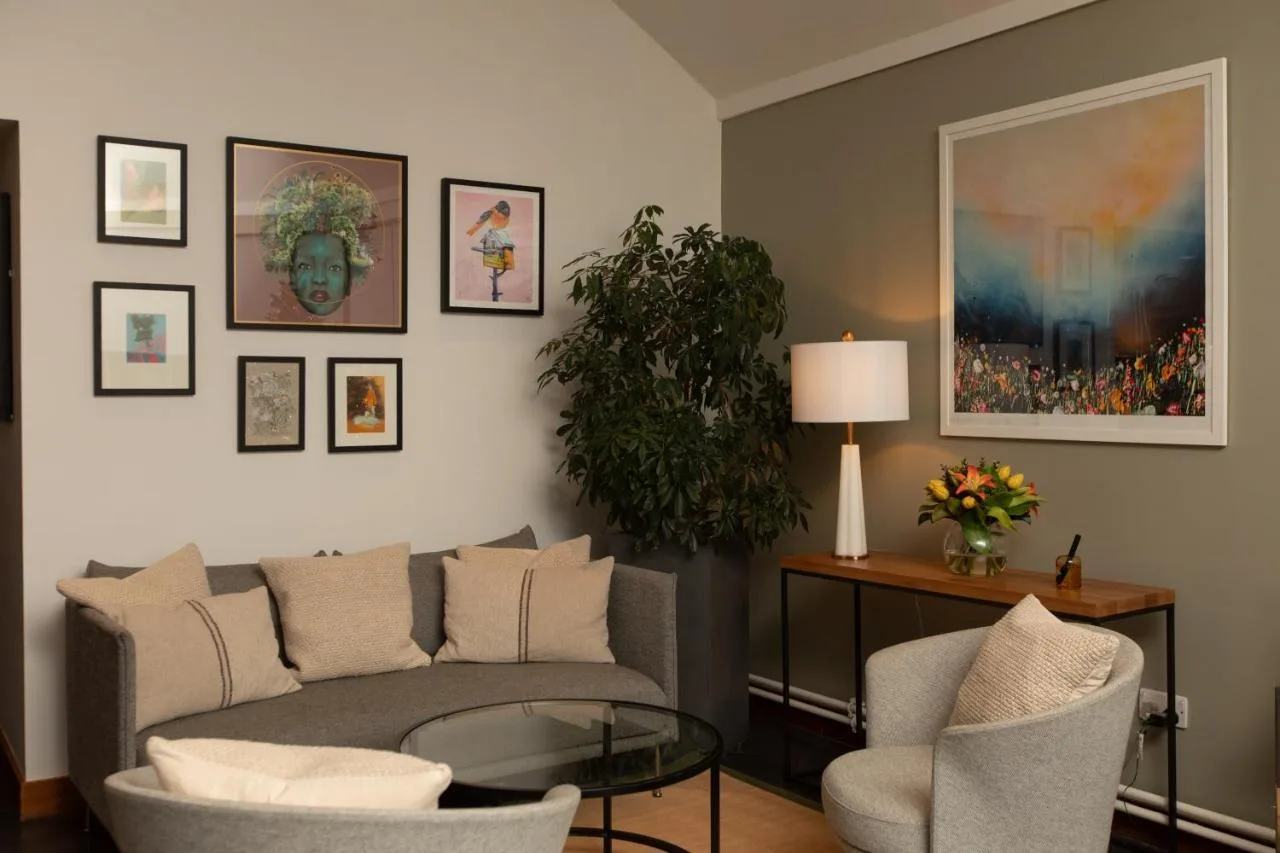 a living room with a couch and chairs and a table at The Scholar in Edinburgh